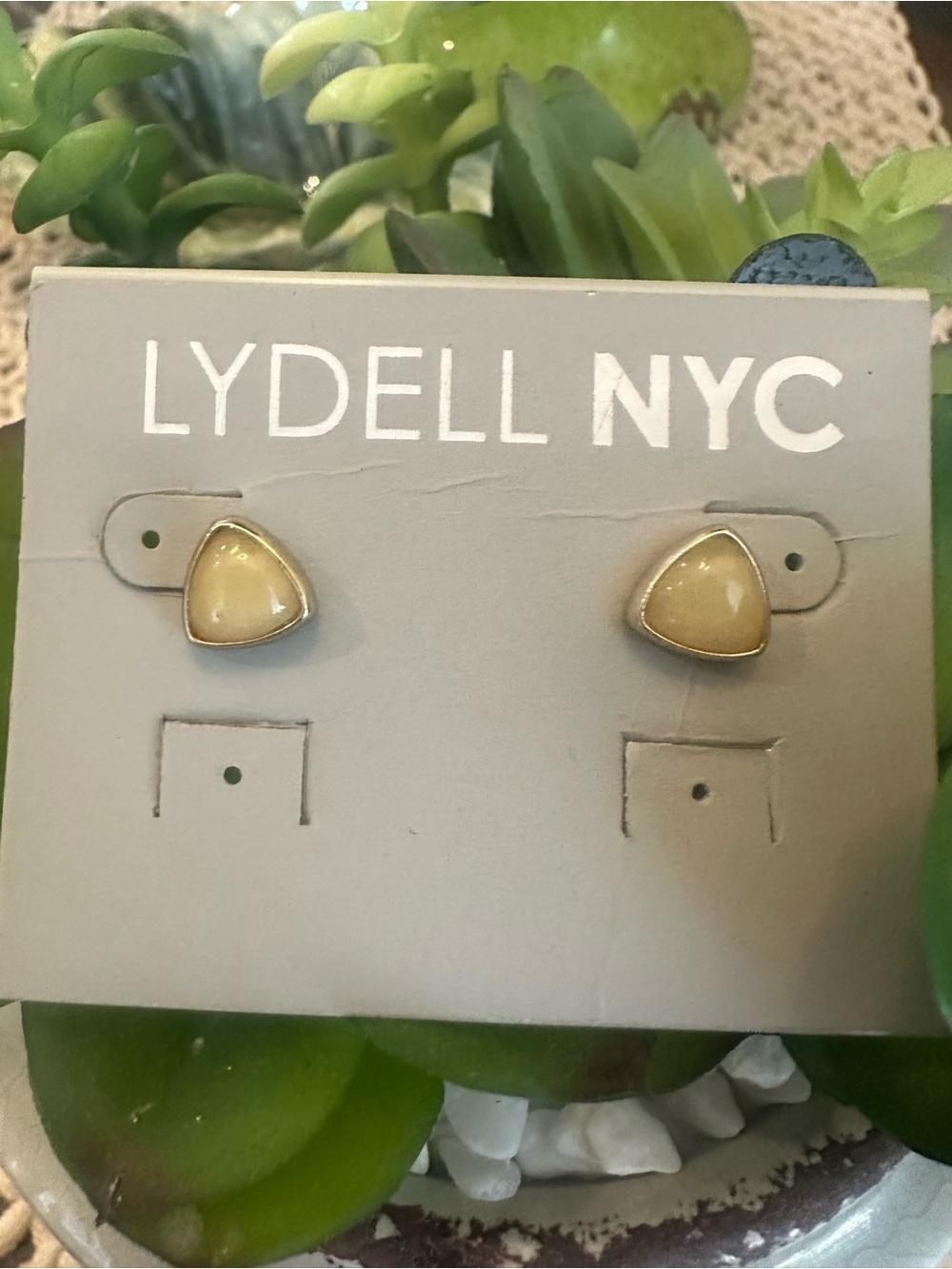 Lydell NYC triangle stud earrings featuring soft yellow or cream-colored stones